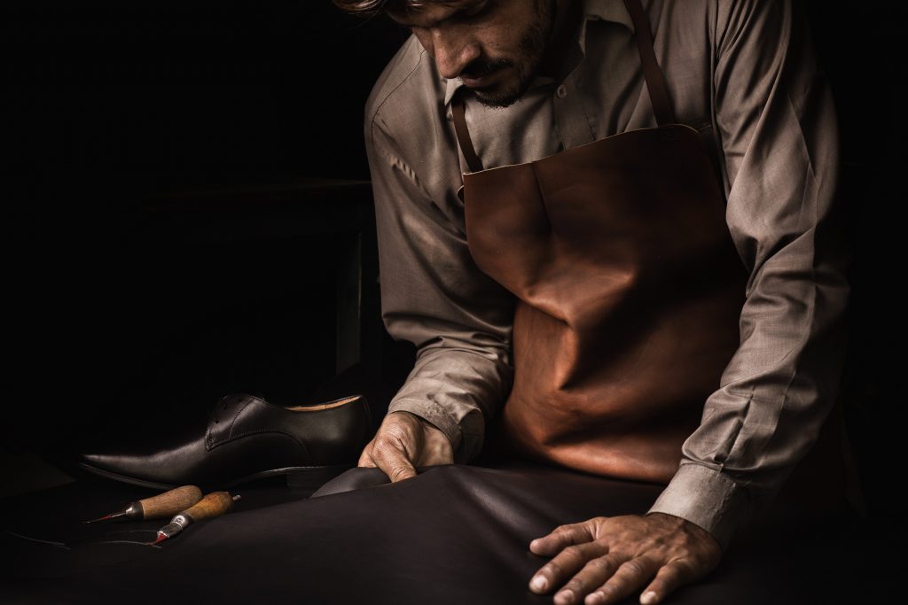 A craftsman, Ijaz, checking the quality of leather before the cutting process